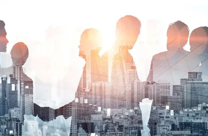 Silhouettes of businesspeople gathered together with a city skyline overlay, conveying collaboration in an urban setting.